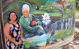 Melanie McTurk with a mural of the late Diane McTurk, her mother-in-law and founder of Karanambu Lodge.