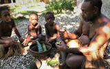 Primo, an adherent of the Moro Movement, works to preserve Solomon Island traditional culture. He welcomes visitors to the village of Lumatapopoho to demonstrate the customs and a lifestyle that is fast-disappearing. Here, he performs a betel nut welcome ceremony as his grandchildren watch.