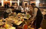 Dining staff in the Starlight dining room on the Empress of the Seas packing hurricane relief meals.