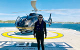Travel Weekly's Johanna Jainchill in front of the Scenic Eclipse's helicopter just after landing on the ship's stern.