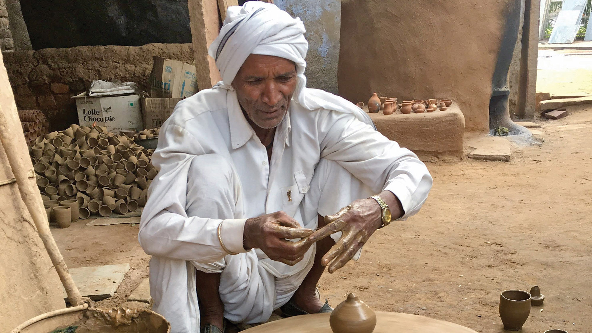 An elderly potter and his wheel in Abhaneri village.