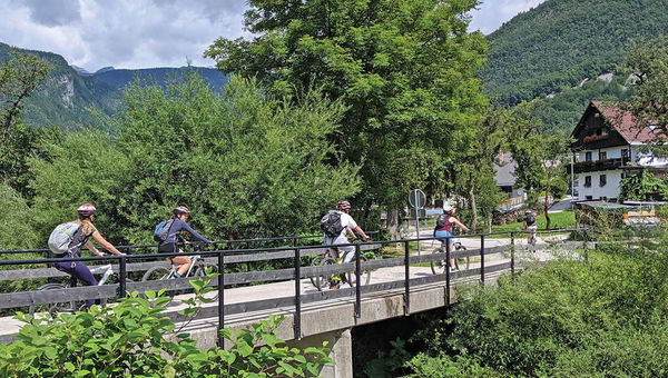 Cyclists crossing a small bridge.