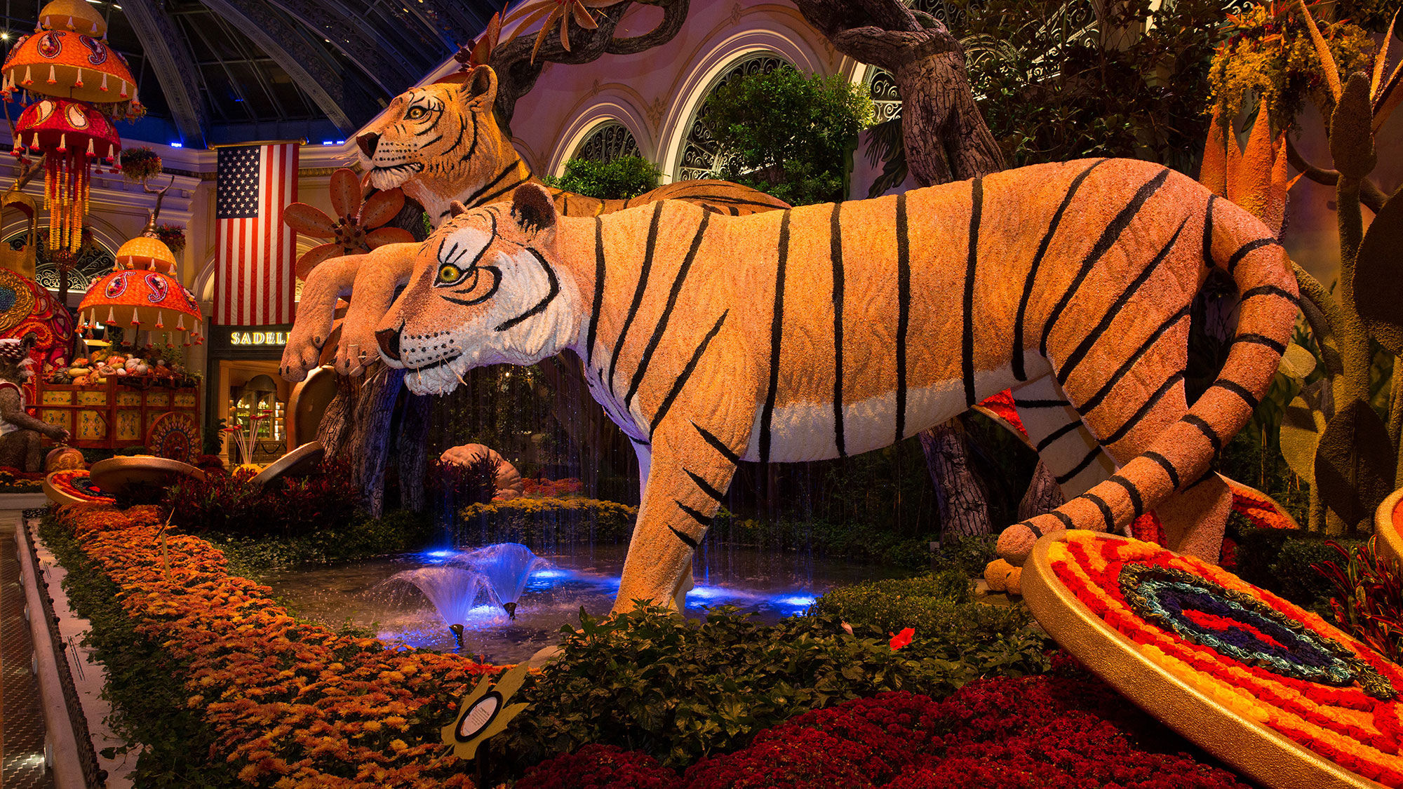 Two 25-foot tigers made from yellow lentils, red and black cargo rice and caraway seeds watch over the North Garden.
