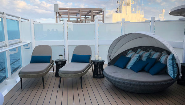 The Sky Suite balcony includes this seating area, which has a large-screen TV and a swiveling clamshell lounger.