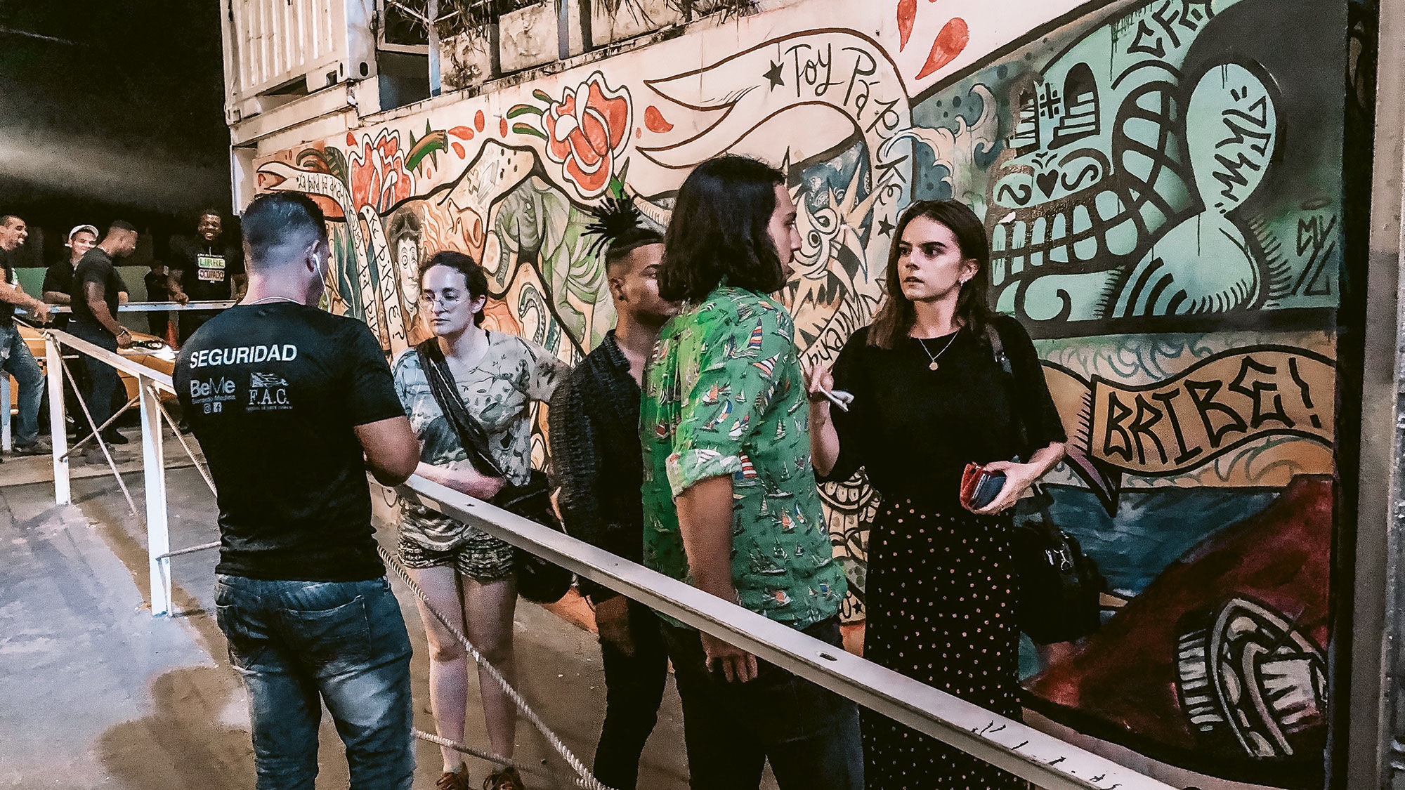 A group of friends stands in line to enter Fabrica de Arte Cubano in Havana.