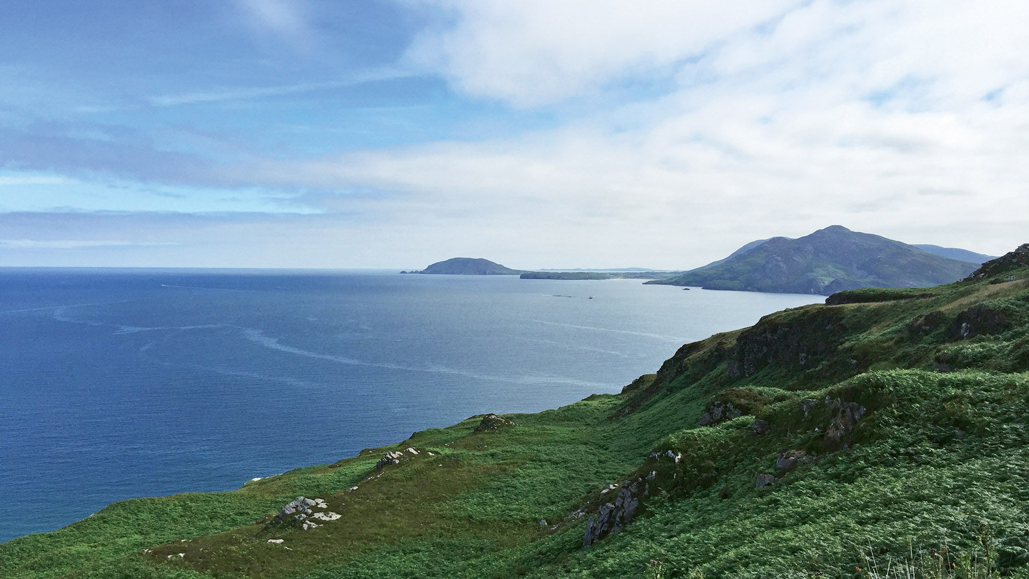 Lough Swilly gleams on a clear day below the green hills of the County Donegal coastline.