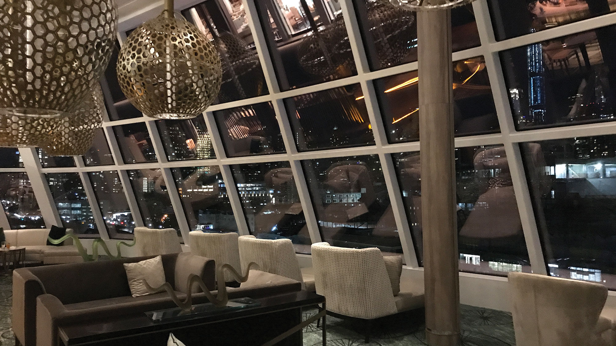 The Observation Lounge on the Norwegian Encore offers ample seating and food and drink options.