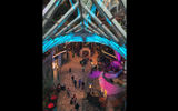 A view of the 2-deck interior promenade on Oasis seen through one of its skylights.
