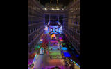A night view of The Boardwalk area of the Oasis, with the new Ultimate Abyss slide in the background.