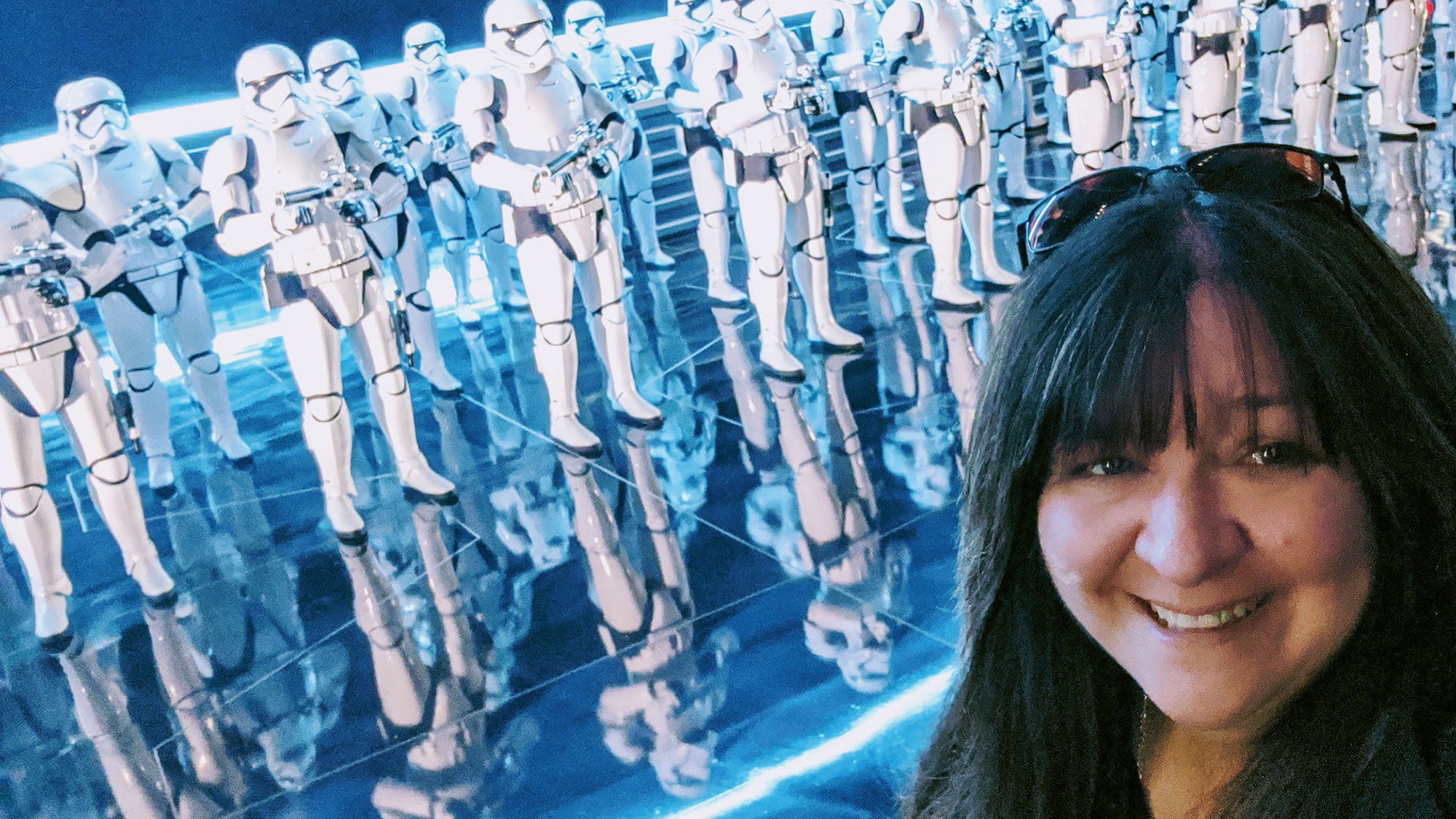 Beci Mahnken, CEO of MEI-Travel in Issaquah, Wash., in front of First Order Storm Troopers on Star Wars: Rise of the Resistance.