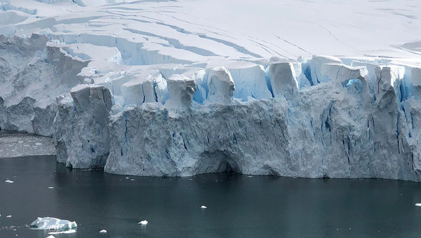 A glacier wall in Antarctica, where the front of a glacier meets the ocean. Large pieces calve off to become icebergs. A glacier wall in Antarctica, where the front of a glacier meets the ocean. Large pieces calve off to become icebergs.