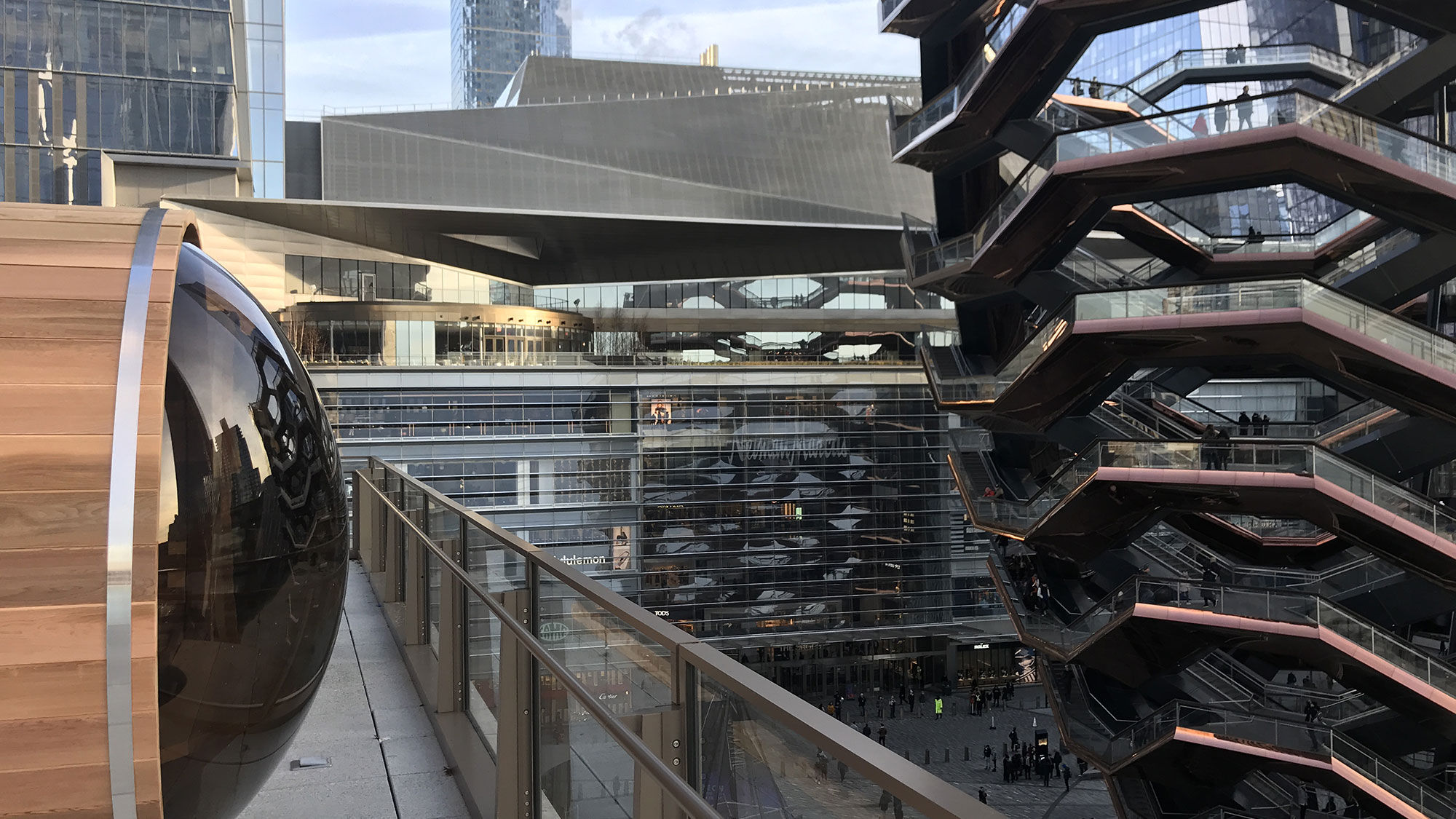 One of Equinox Hotel's barrel saunas overlooks Hudson Yards and the Vessel structure in New York.
