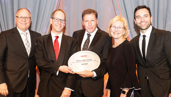 Travel Weekly’s Arnie Weissmann, center, is flanked by Jonathan Hope, Doug Johnson, Inna Germanotta and Josh Mahon of Rocky Mountaineer, which notched its 11th consecutive win in the Rail Vacation category.