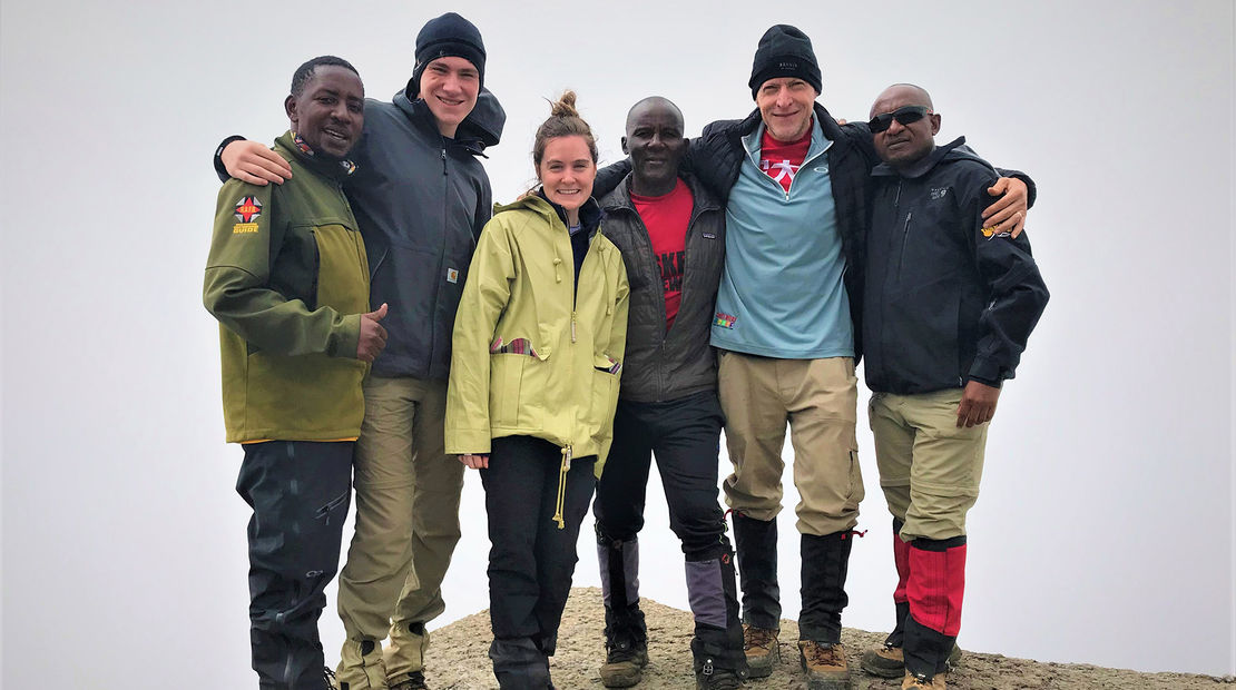 Atop the wall – and glad to have it behind me. Encouragement and helping hands from lead guide Eliakim Mshanga (left), porter Joseph Lymb (to the right of Emma) and assistant guide Pastori Minja (right) came at just the right times during the climb.