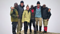 Atop the wall – and glad to have it behind me. Encouragement and helping hands from lead guide Eliakim Mshanga (left), porter Joseph Lymb (to the right of Emma) and assistant guide Pastori Minja (right) came at just the right times during the climb.