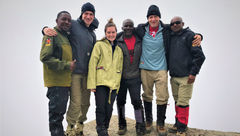 Atop the wall – and glad to have it behind me. Encouragement and helping hands from lead guide Eliakim Mshanga (left), porter Joseph Lymb (to the right of Emma) and assistant guide Pastori Minja (right) came at just the right times during the climb.