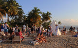Guests enjoy live music and cocktails during the sunset ritual at the Club Med Miches.