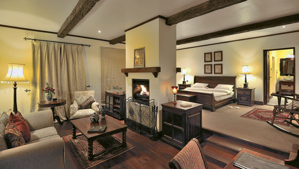 A cottage suite at the luxurious Manor at Ngorongoro, which features a fireplace and a bathtub.
