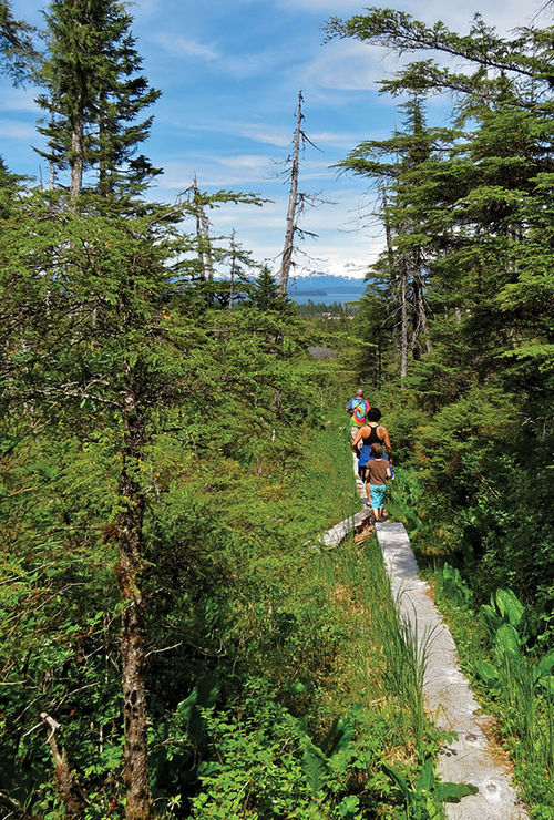 Hikers on the Raven’s Roost Trail near Petersburg on Mitkof Island. Hikers on the Raven’s Roost Trail near Petersburg on Mitkof Island.