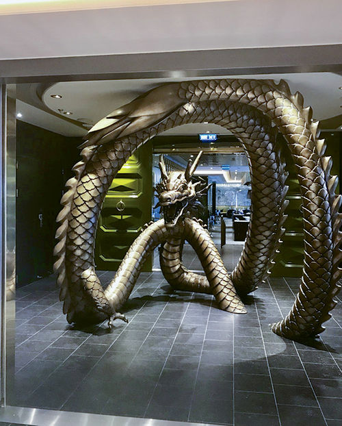Pacific Rim, a Pan-Asian restaurant, features a large dragon sculpture at the entrance. Pacific Rim, a Pan-Asian restaurant, features a large dragon sculpture at the entrance.