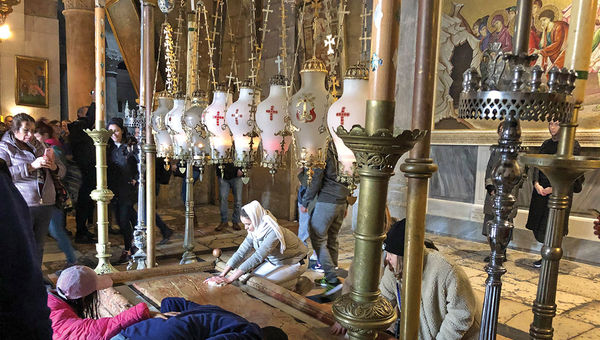 Visitors touch the Stone of Anointing, where Jesus of Nazareth is said to have been prepared for burial, at the Church of the Holy Sepulchre in Jerusalem. Visitors touch the Stone of Anointing, where Jesus of Nazareth is said to have been prepared for burial, at the Church of the Holy Sepulchre in Jerusalem.
