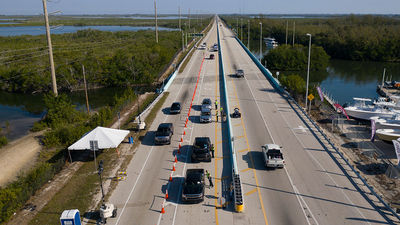 Troopers staff a checkpoint at the entrance to the Florida Keys. While beaches are open in Monroe County, which includes the Keys, the destination remains closed to anyone who doesn't live or work there.