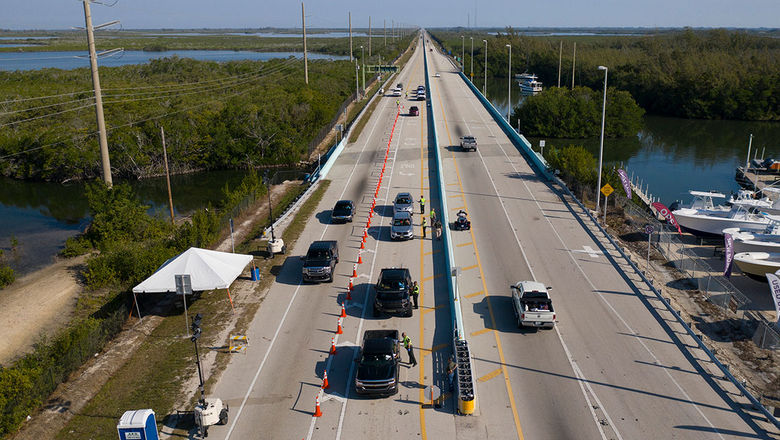 Troopers staff a checkpoint at the entrance to the Florida Keys. While beaches are open in Monroe County, which includes the Keys, the destination remains closed to anyone who doesn't live or work there.