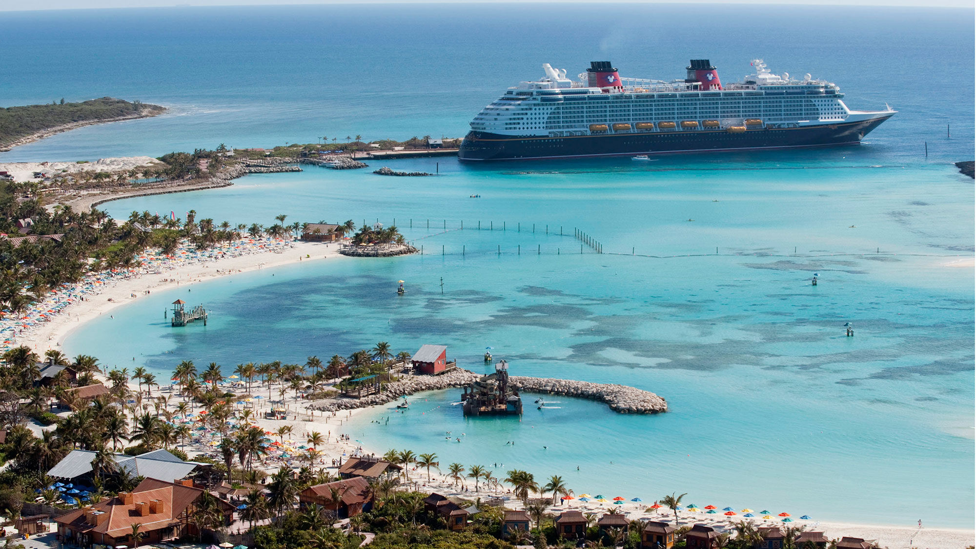 A Disney Cruise Line ship docked at its private island, Castaway Cay.