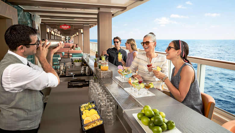 Guests enjoying drinks at the Sugarcane Mojito Bar on the Norwegian Encore.