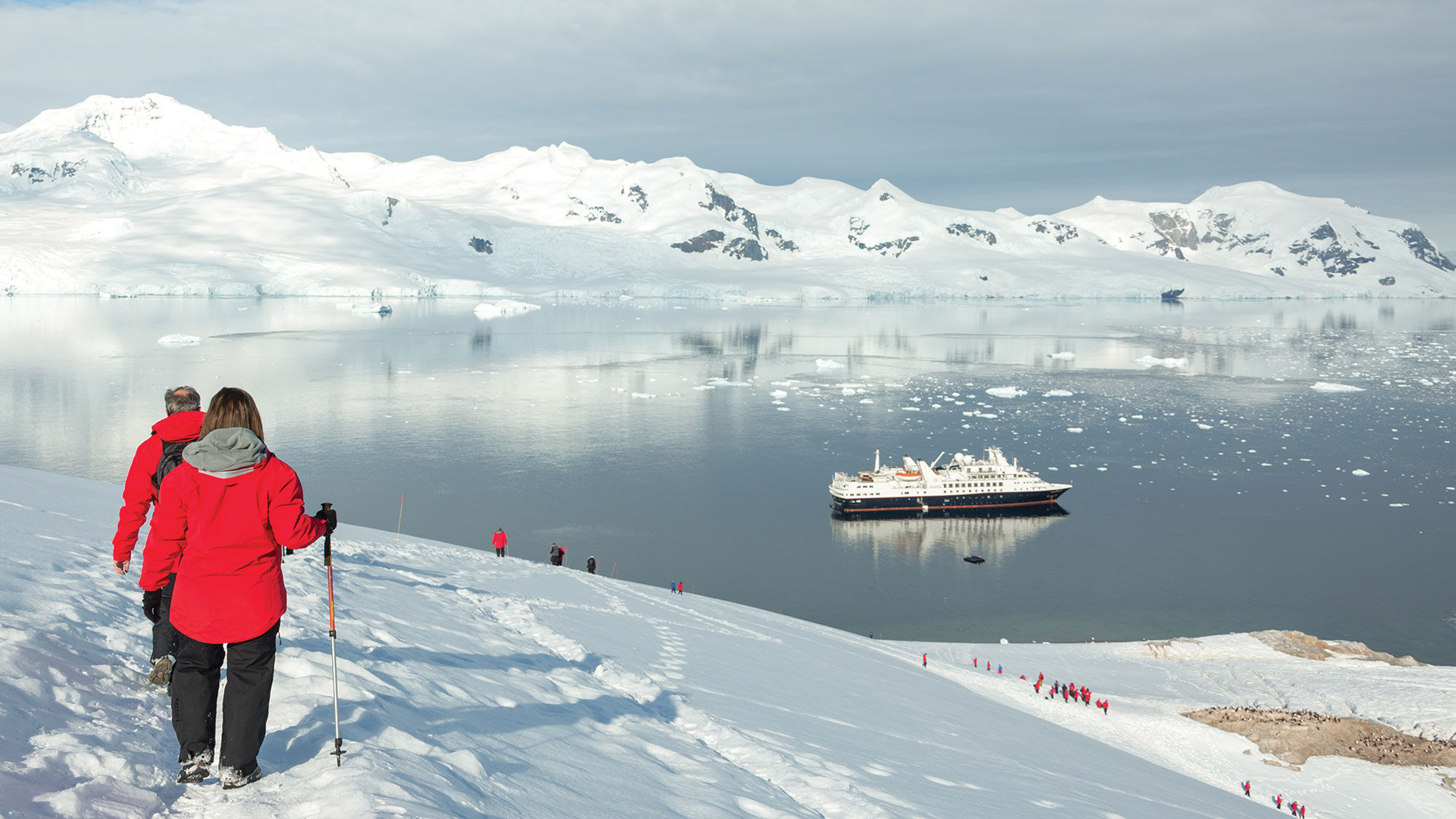 Silversea Cruises guests hiking down from the Neko Harbor overlook on the Antarctic Peninsula.