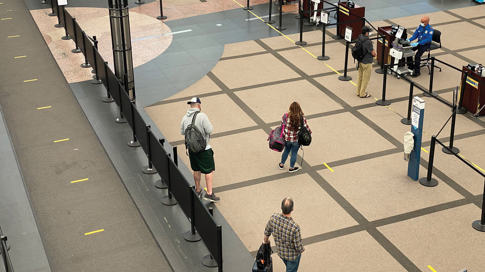 Floor markings encourage social distancing at Denver Airport in late April.