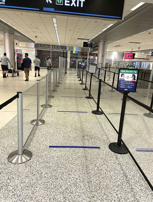 Social-distancing stickers on the floor at Miami Airport. Social-distancing stickers on the floor at Miami Airport.