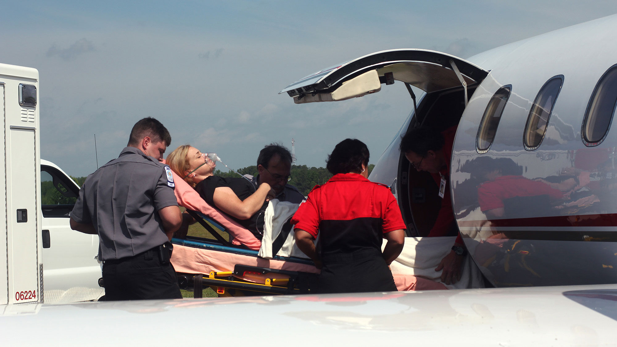 A patient entering a plane for medical air transport.