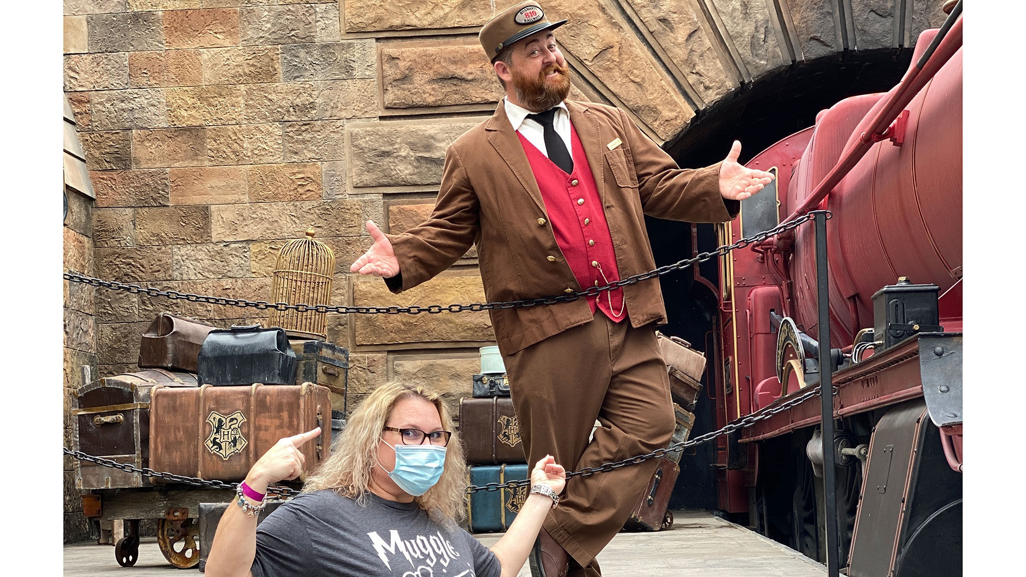 Travel agent Sonya Little taking a photo op with the Hogwarts Express conductor at the Wizarding World of Harry Potter.