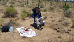 In situ: The author, fortified with provisions and sun protection, as his day of sitting in the Mojave Desert enters its final few hours.