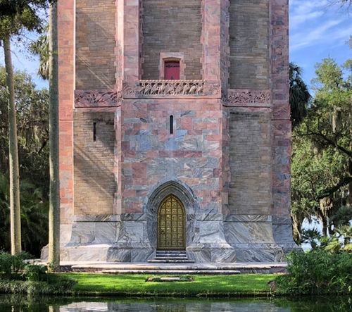 The 205-foot carillon tower is built from pink and gray Georgia marble and coquina stone, and has a frieze of Florida birds over the door The 205-foot carillon tower is built from pink and gray Georgia marble and coquina stone, and has a frieze of Florida birds over the door