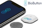 A BioButton, shown with a phone and coin for scale. A BioButton, shown with a phone and coin for scale.