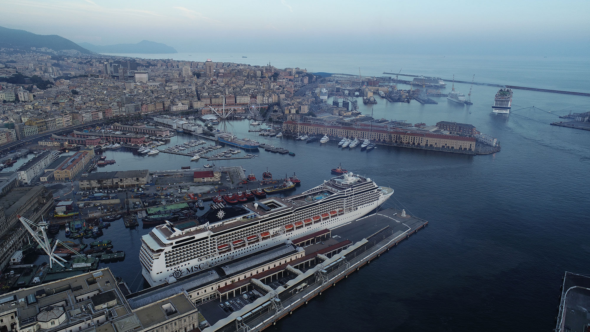 The MSC Grandiosa, top right, departing Genoa, Italy, on its cruise. A family was refused re-embarkation in Naples for violating a shore-tours rule.