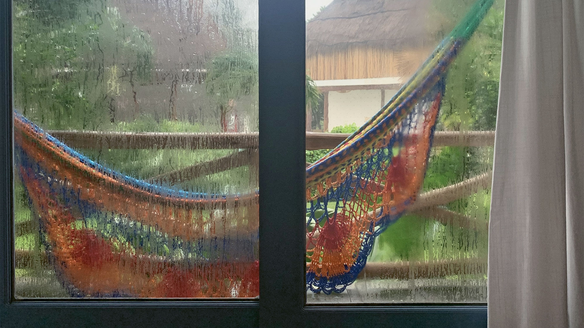 The view of the writer's (unused) hammock during a tropical storm in Holbox, Mexico.
