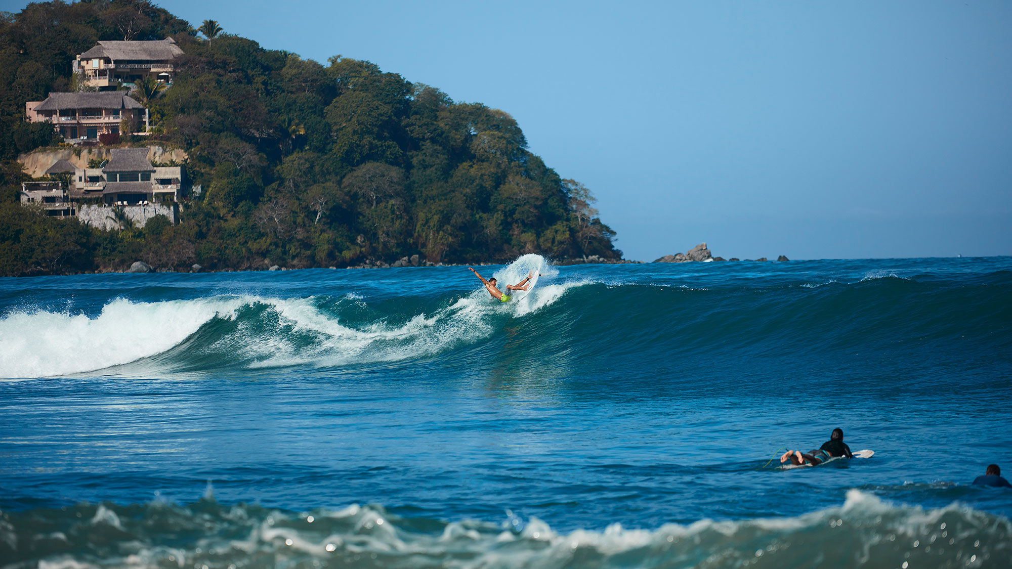 A surfer rides a wave in Sayulita on Riviera Nayarit.