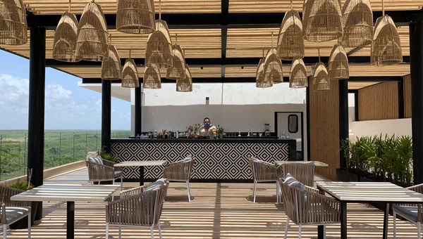 A masked bartender at the Fives Oceanfront resort in Puerto Morelos. A masked bartender at the Fives Oceanfront resort in Puerto Morelos.