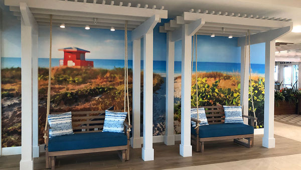 The Compass hotel shares some features found at Margaritaville resorts, such as these gliders in the lobby, but the Jimmy Buffett theming is less prominent. The Compass hotel shares some features found at Margaritaville resorts, such as these gliders in the lobby, but the Jimmy Buffett theming is less prominent.