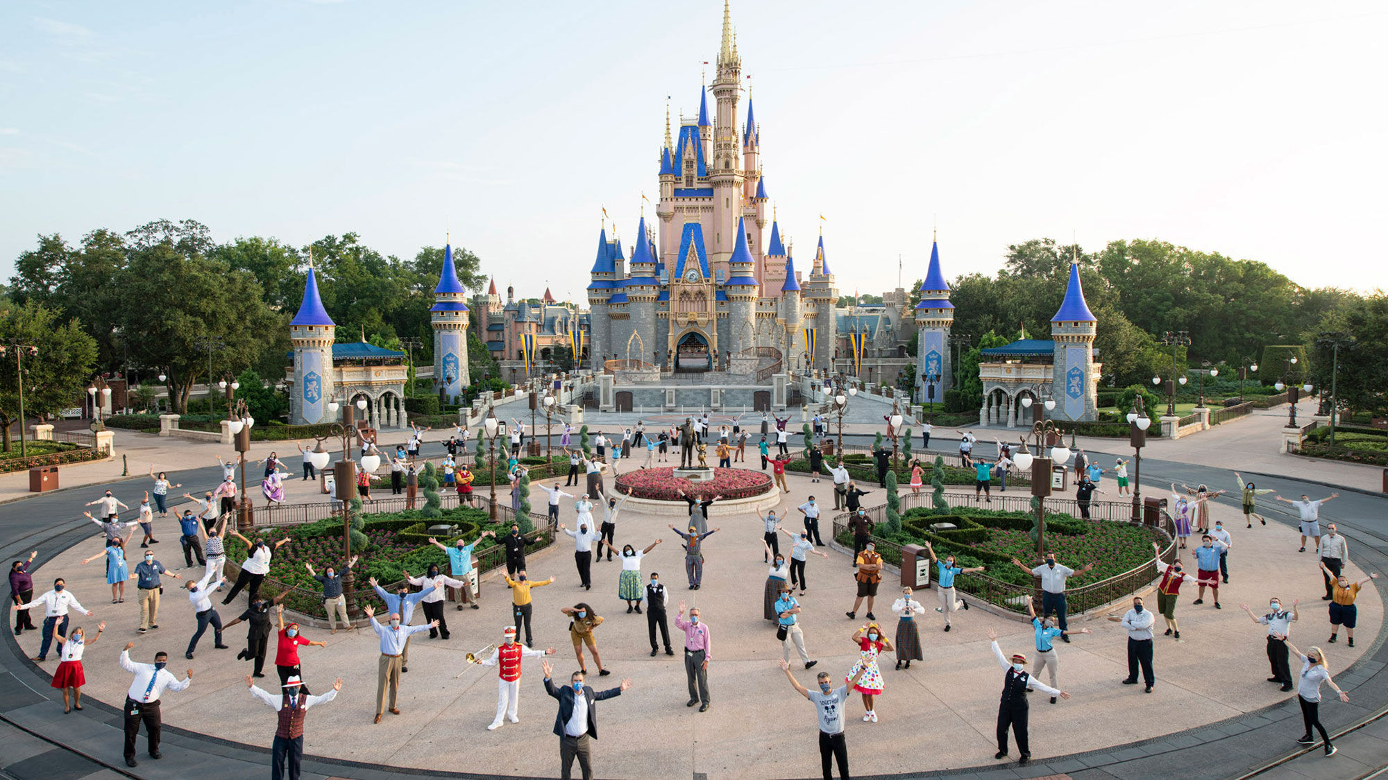 Costumed workers welcome guests to Walt Disney World's Magic Kingdom.