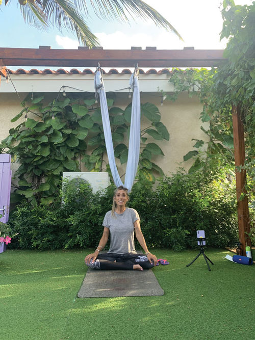 In addition to leading classes at the Hyatt Regency resort in Aruba, Maria Pucci offers private anti-gravity yoga classes in a garden at her home.