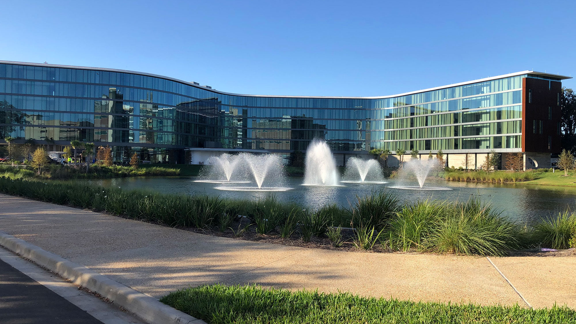 The Hotel ELEO in Gainesville is a six-story, serpentine structure built beside a lake whose five fountains are illuminated at night.