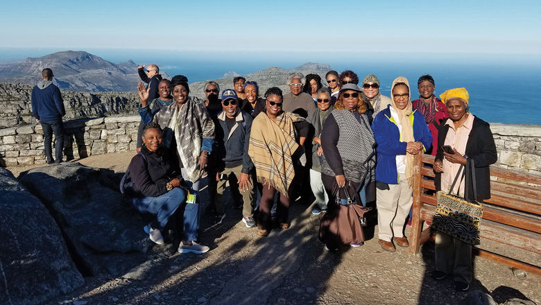 Agency owner Christy Cason, center in tan shawl, with a group in South Africa.