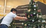 A passenger puts an ornament on a Christmas tree on Hapag-Lloyd's Europa 2, which has been sailing from both Germany and in the Canary Islands.