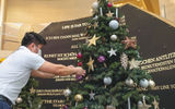 A passenger puts an ornament on a Christmas tree on Hapag-Lloyd's Europa 2, which has been sailing from both Germany and in the Canary Islands.