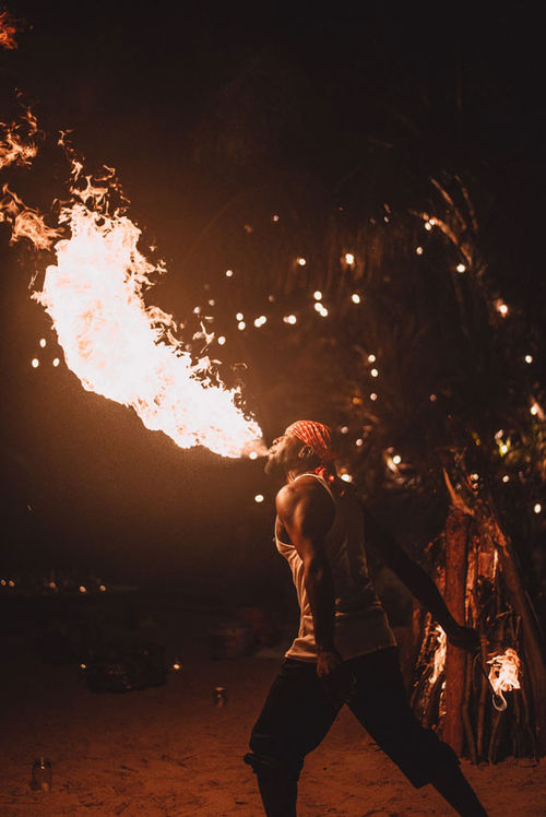 A fire eater entertains guests during an Island Routes Bespoke Collection (customized) experience.