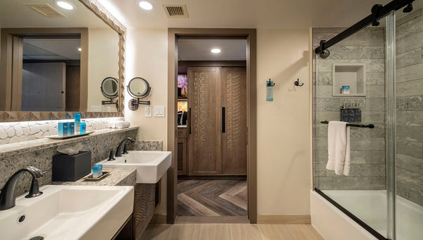 Bathrooms showcase ocean floor-inspired tiling and vanities with decoratively carved details. Bathrooms showcase ocean floor-inspired tiling and vanities with decoratively carved details.